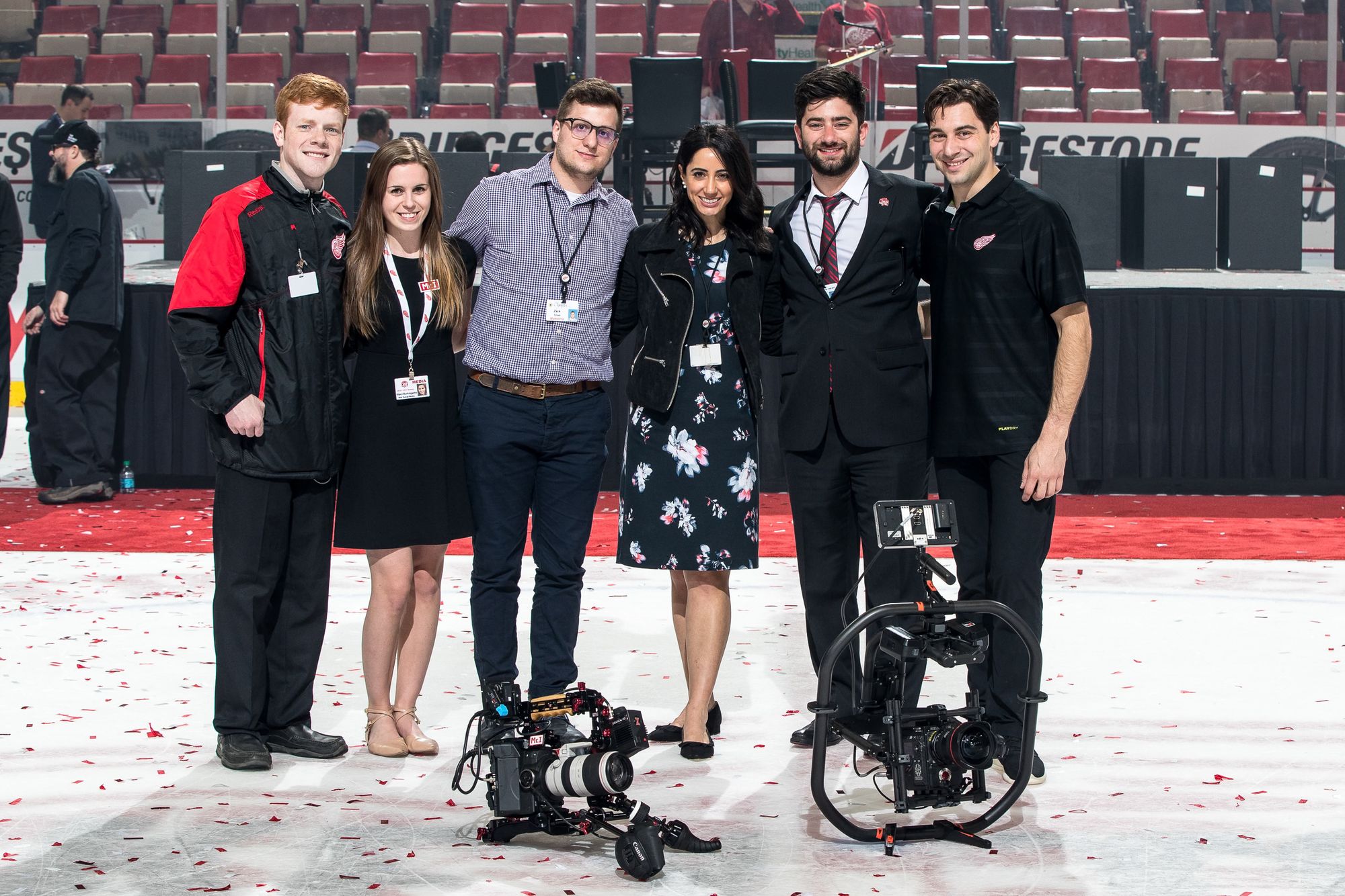 The Red Wings production crew posing on the ice with camera rigs after a game