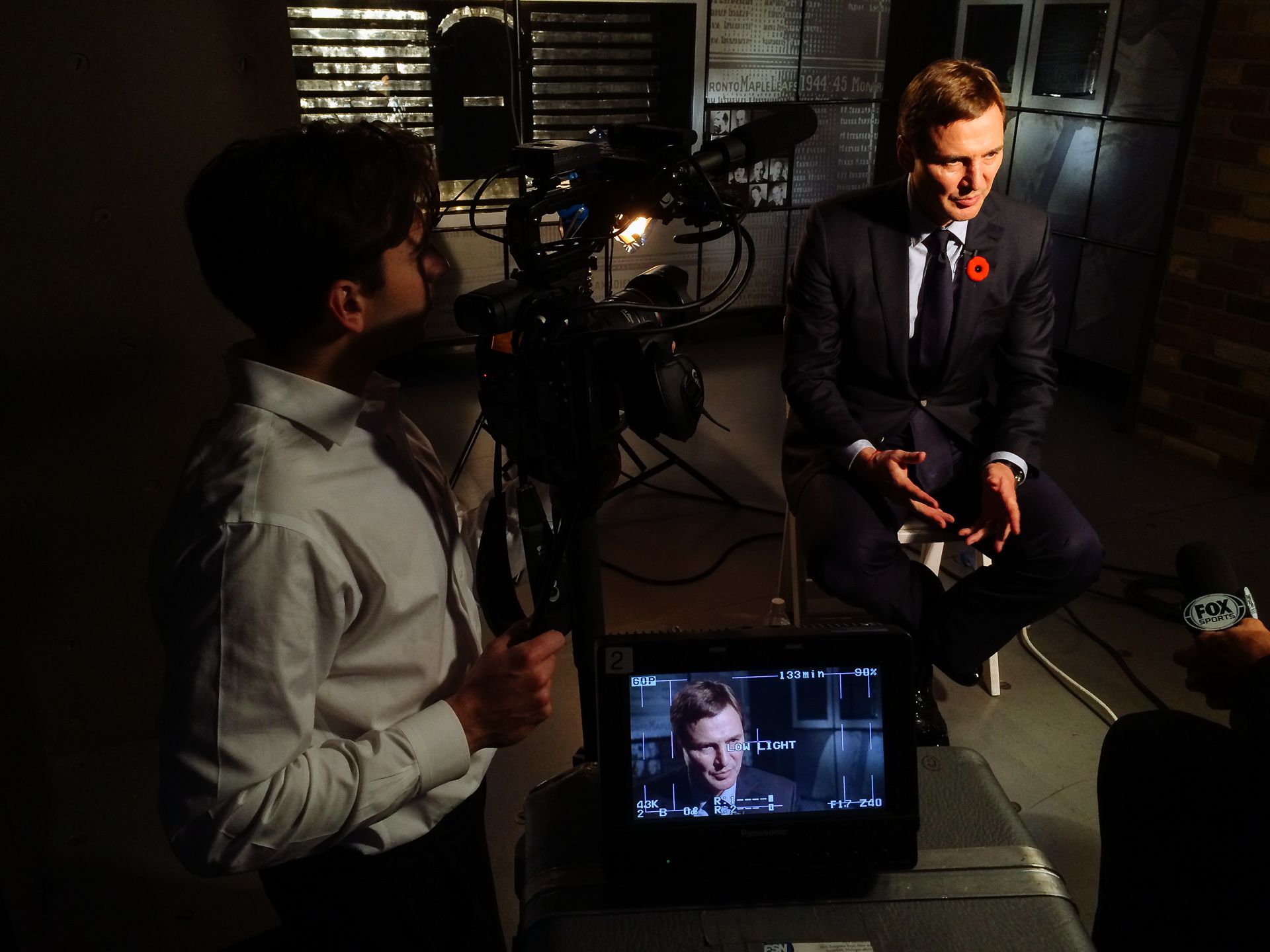 A lit interview setup with a player on camera and a monitor in the foreground