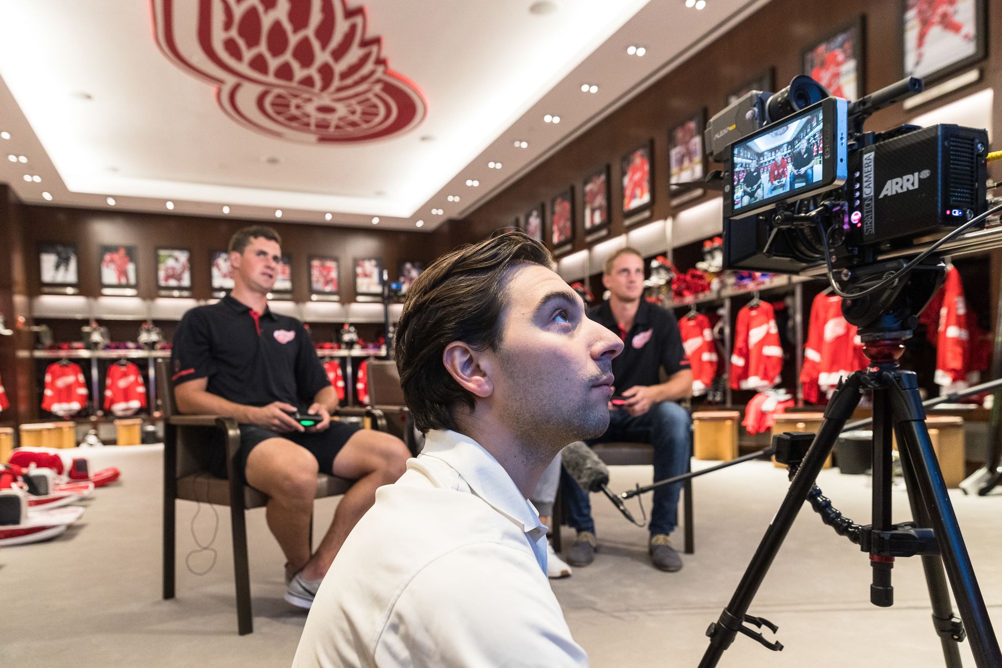 Dan watching a field monitor during a locker room interview setup