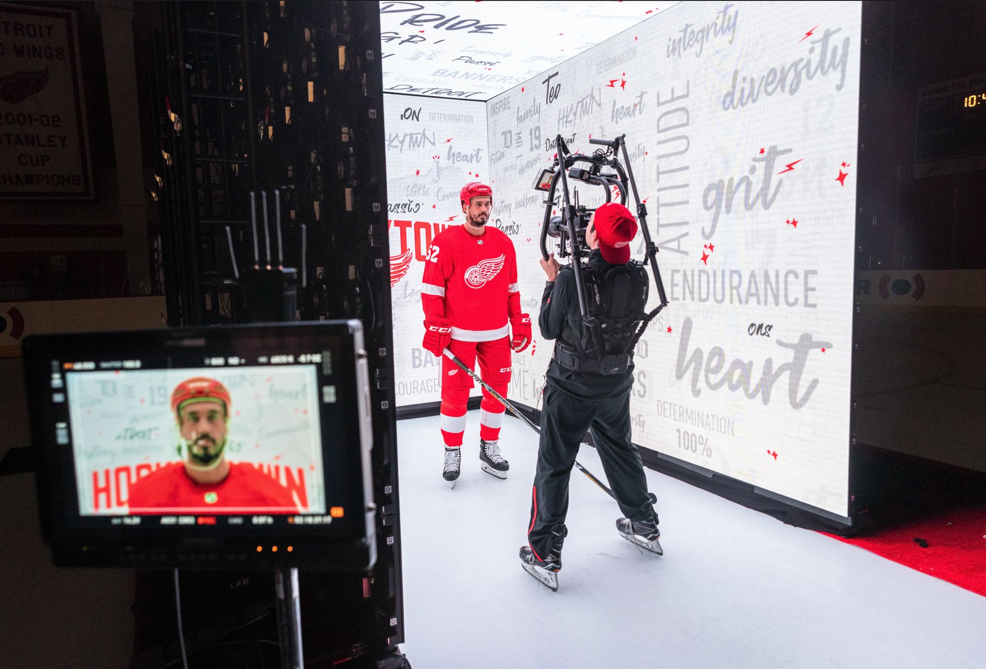 A monitor shows a Red Wings player filmed on a gimbal in a lettered tunnel set